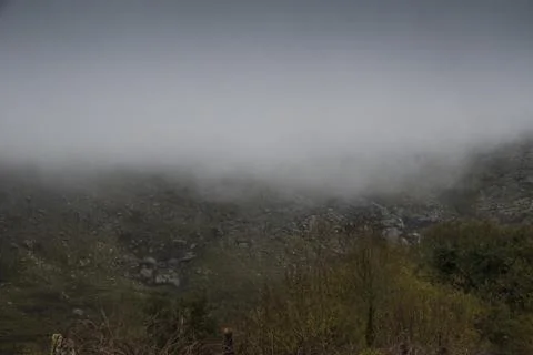 Clouds lifting up from the mountains Stock Photos