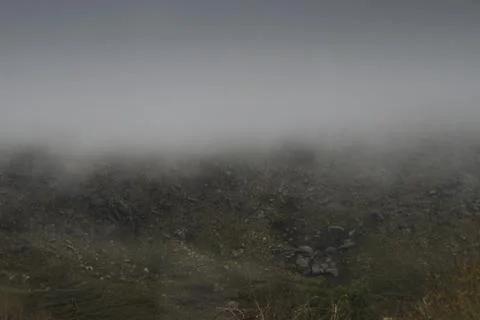 Clouds lifting up from the mountains Stock Photos