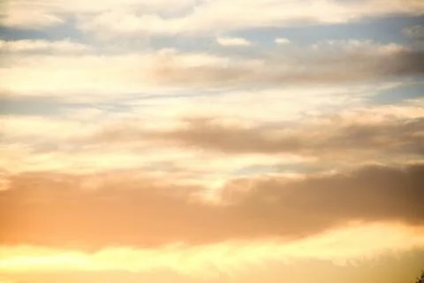 Clouds lit up in the sky at sunset.	2 Stock Photos