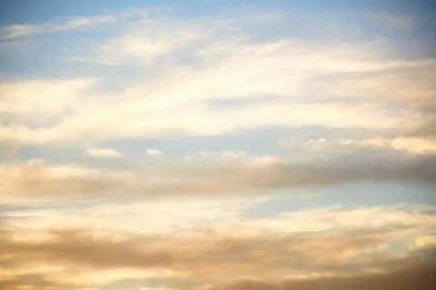 Clouds lit up in the sky at sunset.	 Stock Photos
