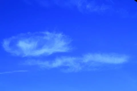 Clouds looking like a snail through blue sky Stock Photos