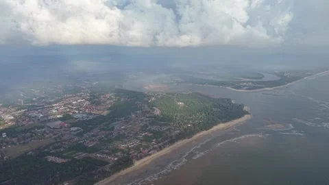 Clouds loom above coastal town and river delta 库存影片 337984356