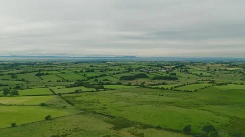 Clouds loom low over rolling green fields Stock Footage 345525534