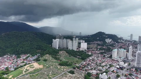 Clouds loom over urban hills, rain begins to fall Stock Footage 344809675
