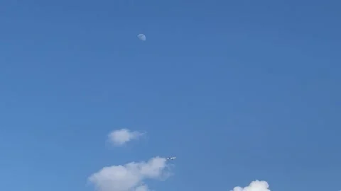 Clouds, Moon, Flying Plane In Clear Blue Sky Background Stock Footage 182153466