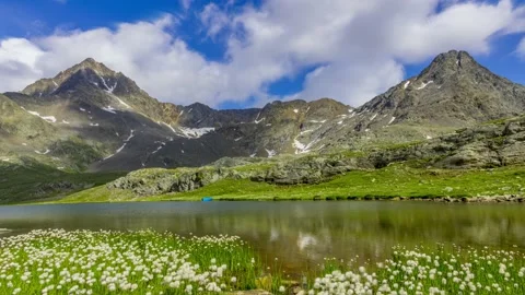 Clouds mooving on the mountain reflected on the white lake at gavia Pass Stock Footage 167654134