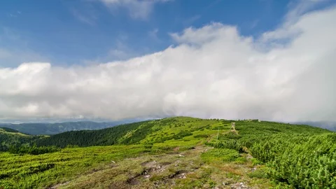Clouds motion over green Carpathian mountains ridge in sunny summer time lapse Stock Footage 107995954