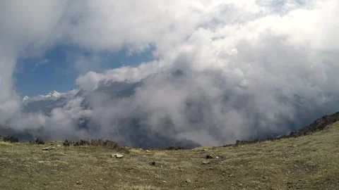 Clouds in mountain valley in Himalayas next to Sunder Peak mountain Stock Footage 284643829