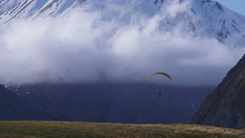 Clouds, mountains and a paraglider Stock Footage 171991394