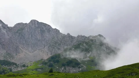 Clouds in the mountains. The fog is moving rapidly through the mountain valley Stock Footage 137242602