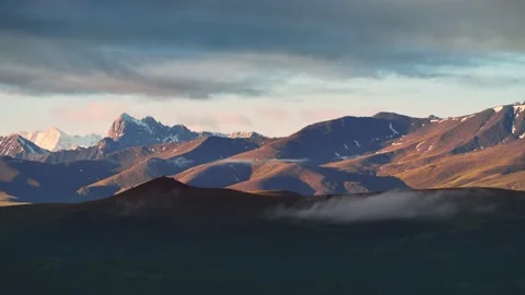 Clouds in the mountains at sunrise timelapse. Stock Footage 219569755