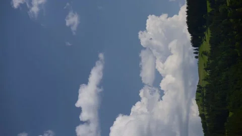 Clouds, mountains, trees, green grass and blue sky movement. Stock Footage 245611606