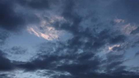 Clouds move across the evening sky in the blue hour. Birds fly through the sky. Stock Footage 164668153