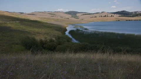 Clouds move across a lake and grasslands in the interior of British Columbia,4k Stock Footage 151298428