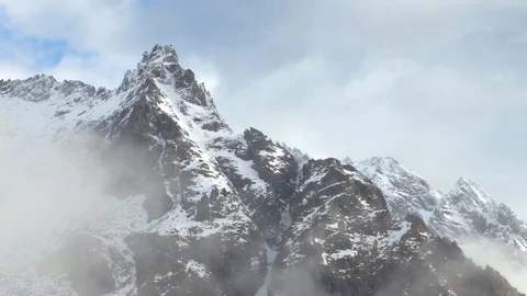 Clouds move against the backdrop of the mountain in the Alps 스톡 동영상 77584996