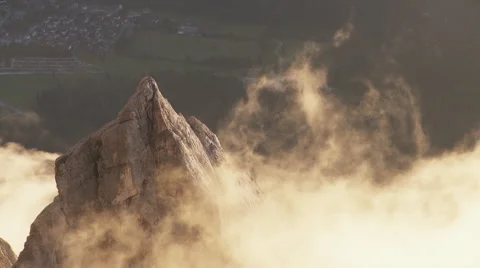 Clouds move around mountain peak in sunset Stock Footage 58630910