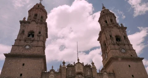 Clouds move between two bell towers of the Morelia Cathedral church in Mexico Stock Footage 93897134