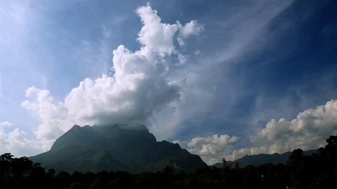 Clouds move over mountain Stock Footage 97207048