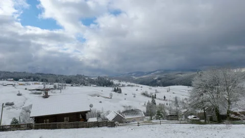 Clouds move over the mountains and the village in winter Stock Footage 155533128
