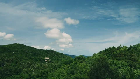 Clouds move over the mountains on the island 動画素材 154421521