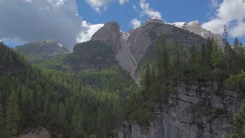Clouds move over mountains of unusual shape on a sunny day 스톡 동영상 77660745