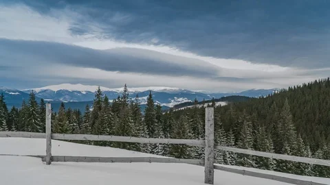 Clouds move over the mountains in winter Stock Footage 128029687