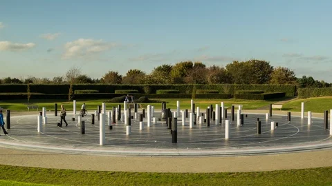 Clouds move over a set of columns at an arts installation in Milton Keynes. Stock Footage 115956355