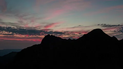 Clouds Move Over A Silhouetted Mountain During Golden Hour ZoomIN Stock-Footage 87289288