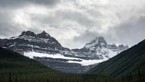 Clouds move over snow capped mountains along the Icefields Parkway Stock Footage 69827669