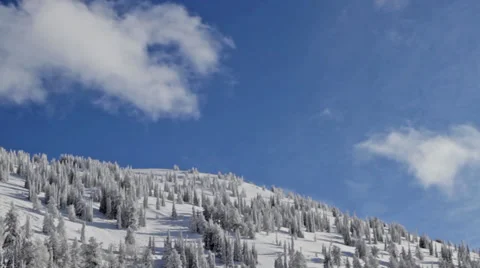 Clouds move over a snowy mountain in Wyoming Stock Footage 36318011