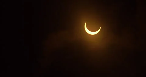 Clouds move to reveal a partial annular solar eclipse, October 14th, 2023. Stock Footage 253371845