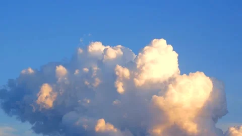 Clouds move slowly across the sky, beautifully illuminated by the setting sun Stock Footage 134901814
