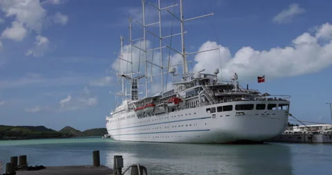Clouds move slowly by five mast sailing ship docked at St. John, Antigua Stock Footage 232843438