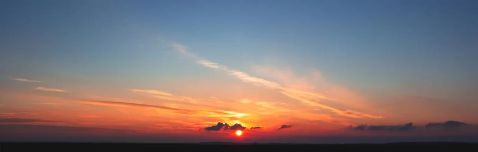 Clouds move towards the sun Stock Photos
