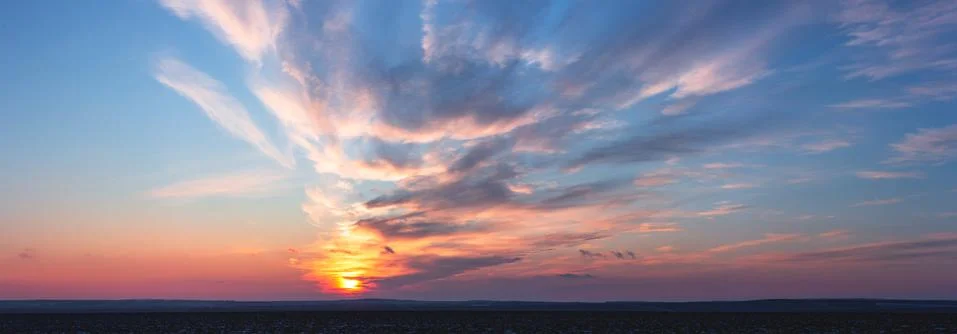 Clouds move towards the sun Stock Photos