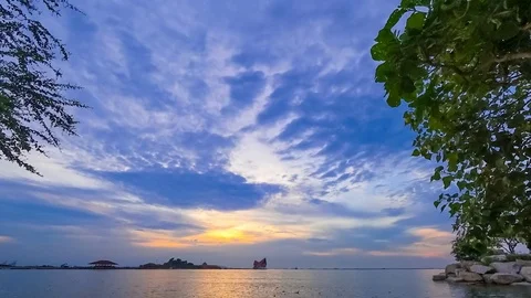 Clouds movement in sky at sea with silhouette of tree foreground,Time lapse Stock Footage 80245407