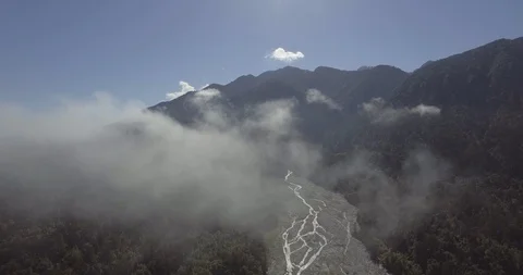 Clouds moving above dense mountain forest Stock Footage 119165942