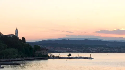 Clouds moving above lake garda at sunset Stock Footage 287821063