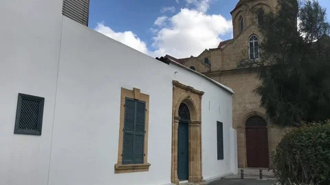 Clouds moving above an Old House and a Church Time lapse Stock Footage 90954389