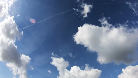 Clouds Moving Across the Blue Sky Against a Background. Timelapse. Stock Footage 96099659