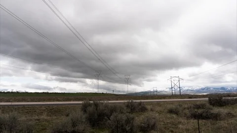 Clouds moving across desert sky with powerlines Stock Footage 113509198