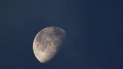 Clouds moving across the moon at dawn during Waning Gibbous phase Stock Footage 247511199