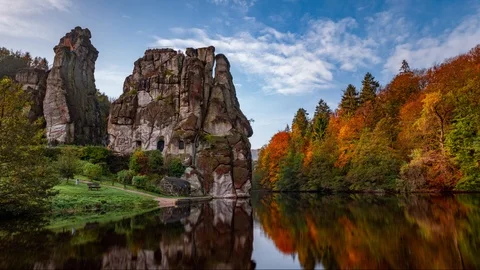 Clouds moving across the sky cast shadows on the mountains and the lake. Stock Footage 125704778