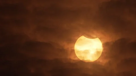 Clouds moving across the sky looking up at the Sun during eclipse Stock Footage 253297161