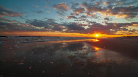 Clouds moving across the sky, reflecting in ocean waves as the tide rises. Stock Footage 133205642