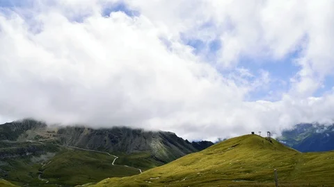 Clouds moving in Alpine valley against mountains and sky station Stock Footage 111942825