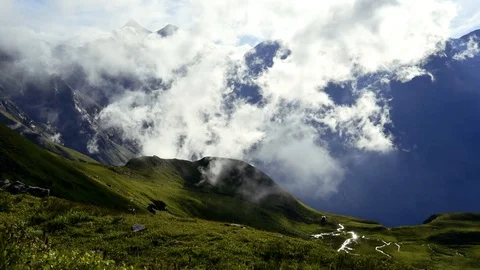 Clouds moving in Alpine valley against mountains Stock Footage 111942994
