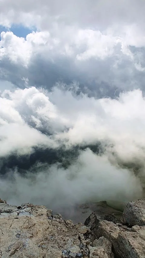 Clouds moving around rocky alpine peaks and ridges in a slow-motion manner Stock Footage 248379578