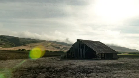 Clouds moving behind an abandoned barn Stock Footage 154917301
