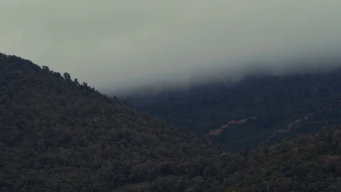Clouds moving behind mountains Stock Footage 88715208